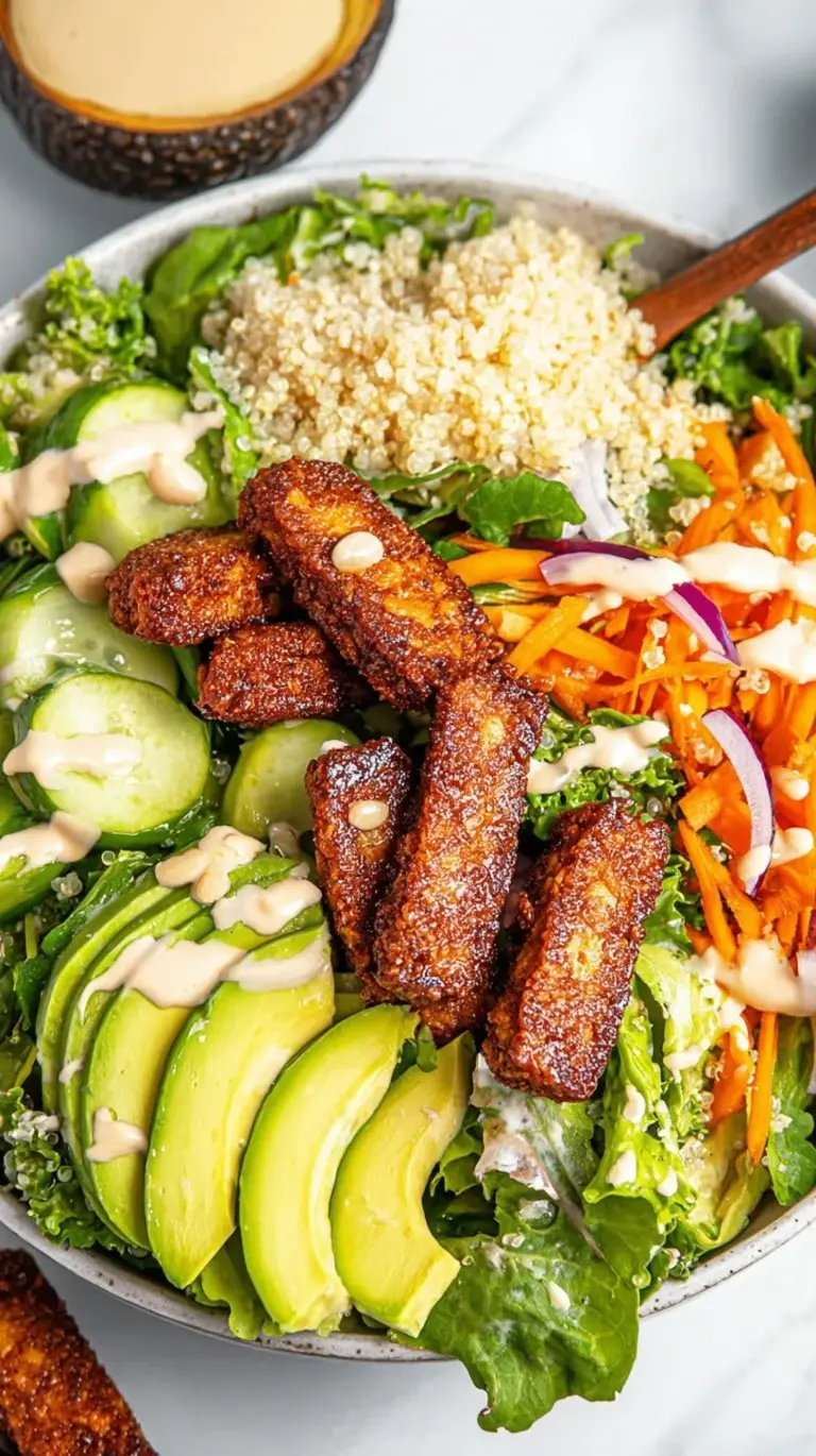 A vibrant salad bowl topped with charred, spice-rubbed tempeh strips, cherry tomatoes, and cucumbers.