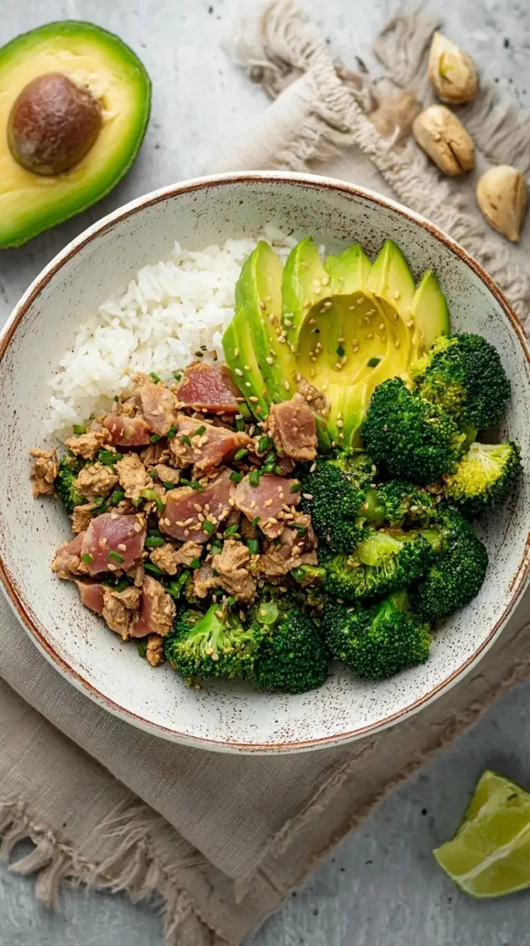 A fresh Broccoli Avocado Tuna Bowl with lemon dressing and red chili flakes.