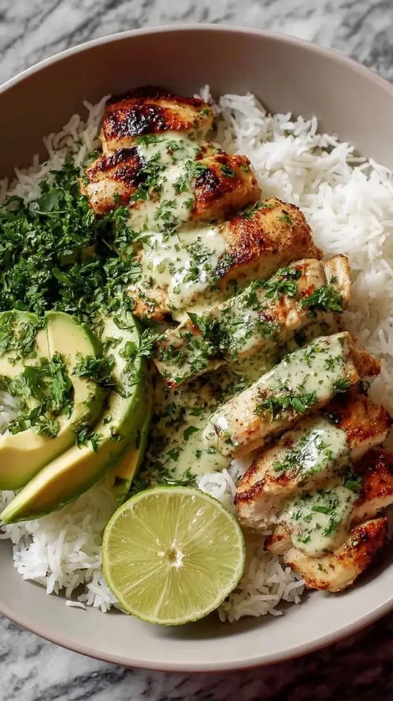 Seared cilantro lime chicken strips served over jasmine rice with sliced avocado and lime wedges