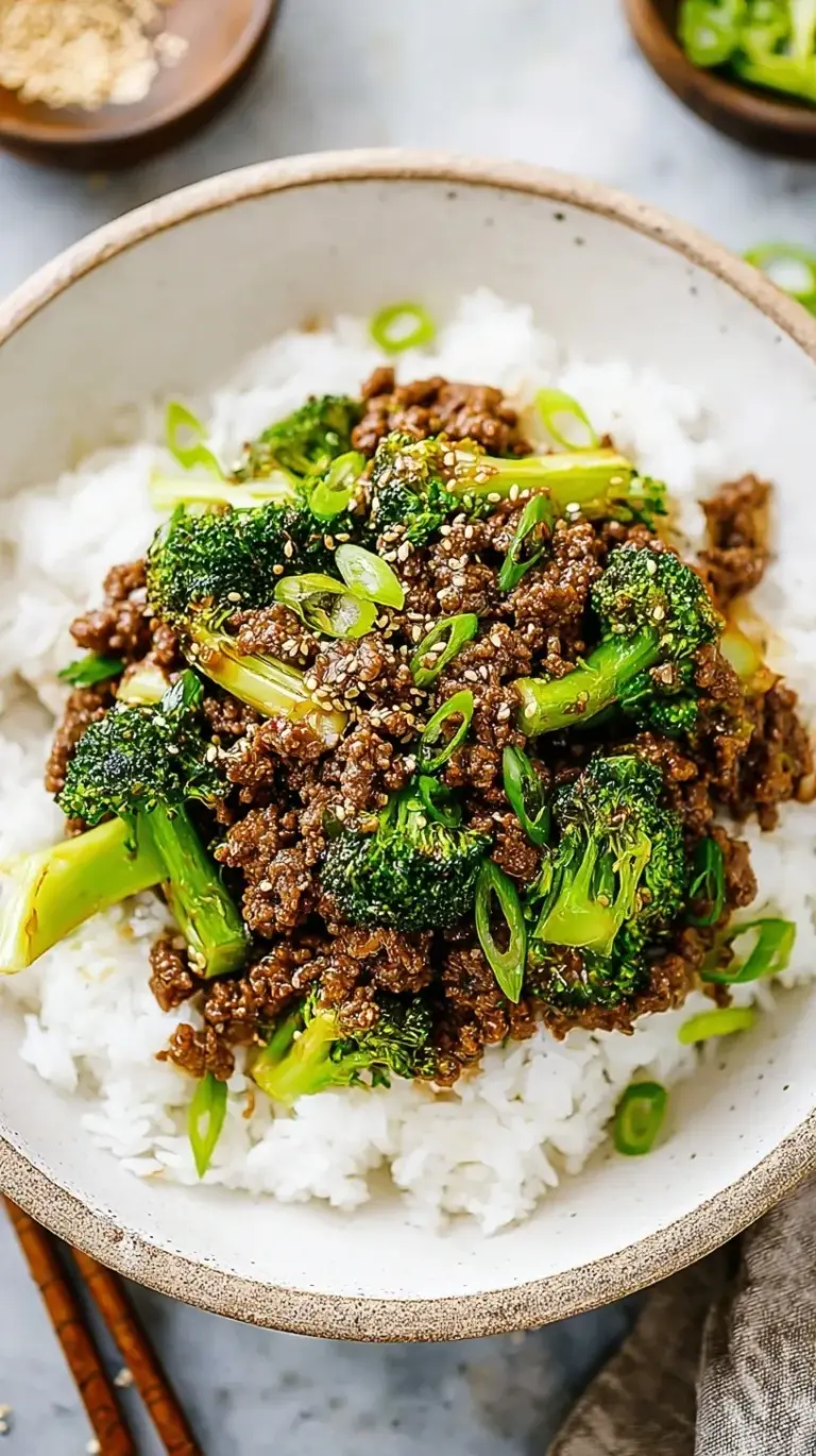 A skillet filled with browned ground beef and vibrant green broccoli in a glossy brown sauce.
