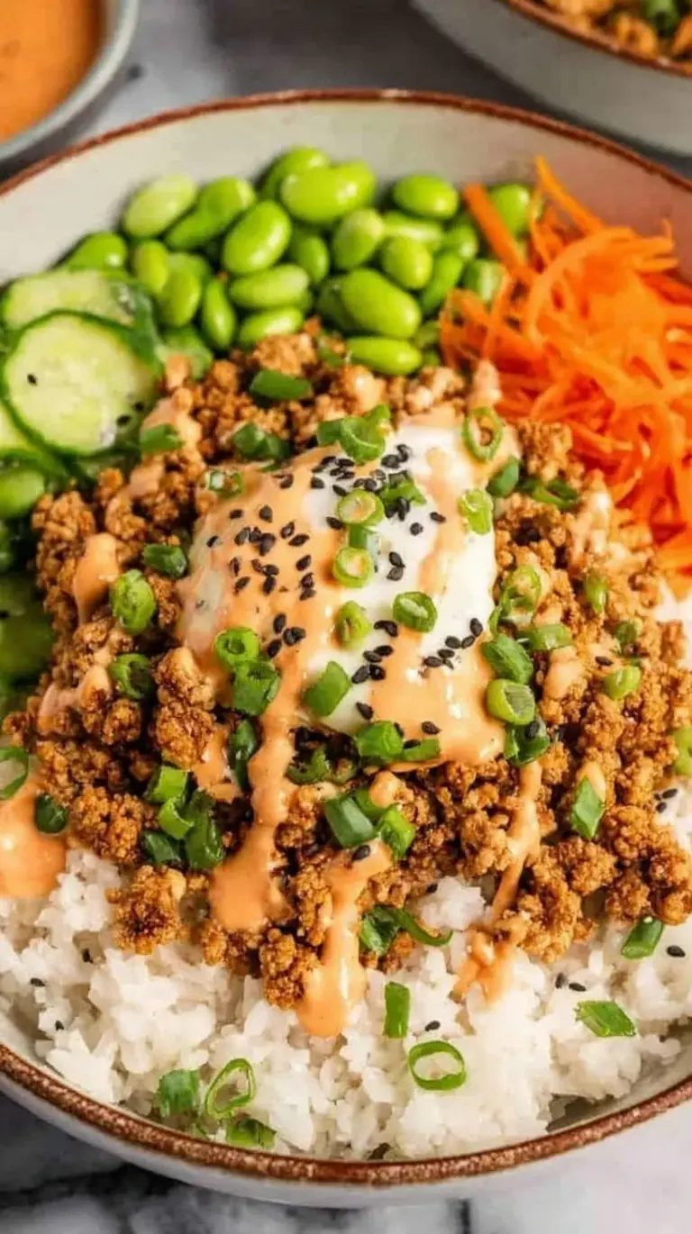 A white bowl filled with seasoned ground turkey, sautéed peppers, and white rice garnished with green onions.