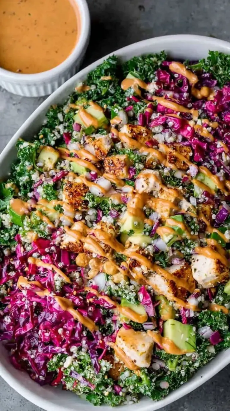 Four glass meal prep containers filled with grilled chicken, chickpeas, cucumbers, and feta over baby spinach.