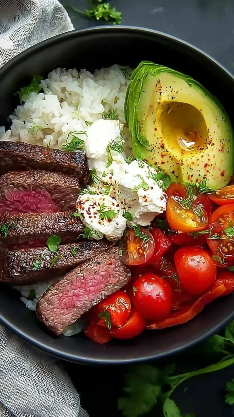 A vibrant steak fajita bowl with seared beef, charred peppers, and avocado over cilantro lime cauliflower rice.