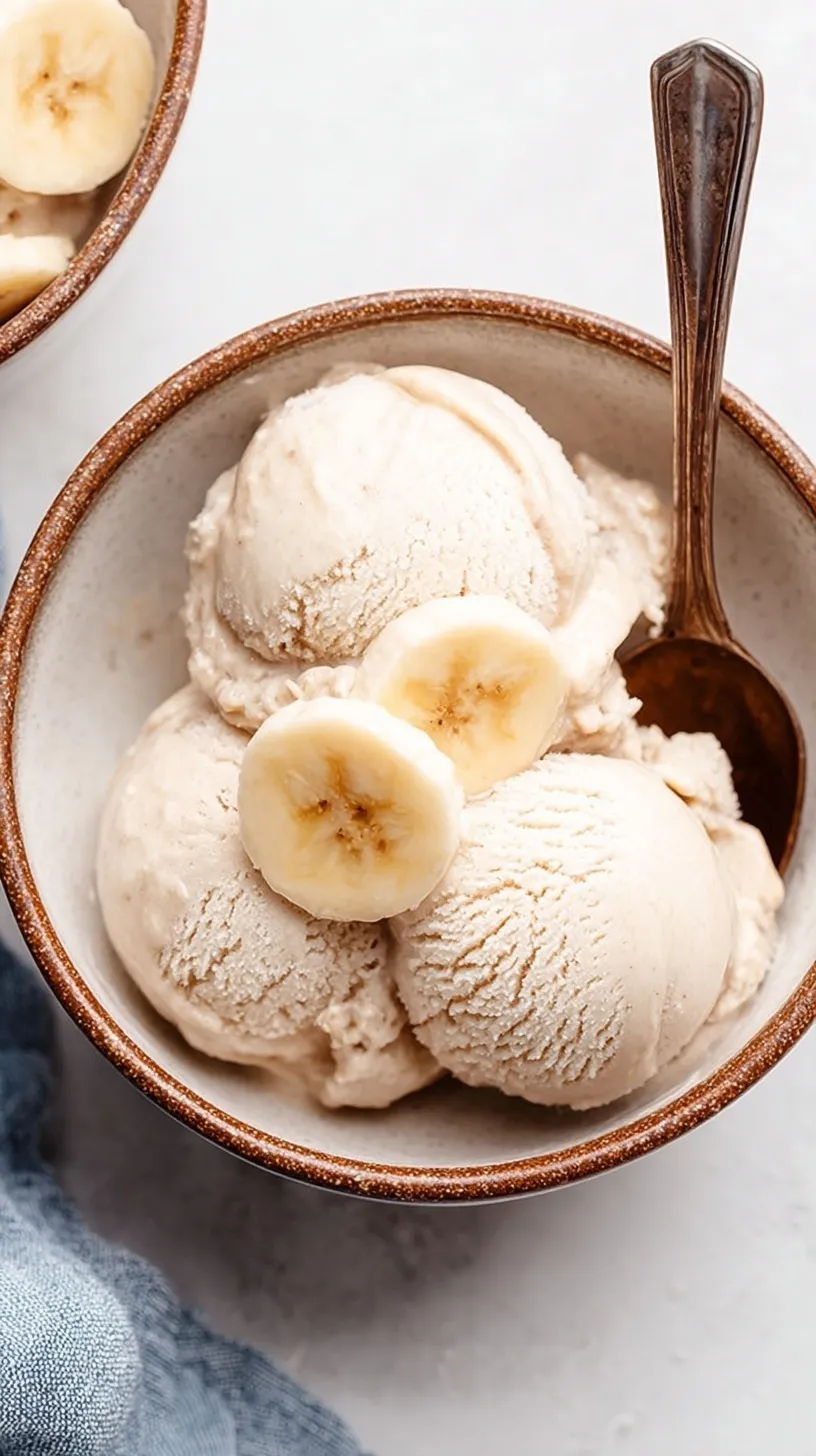 A bowl of smooth, creamy one ingredient banana ice cream topped with fresh fruit.