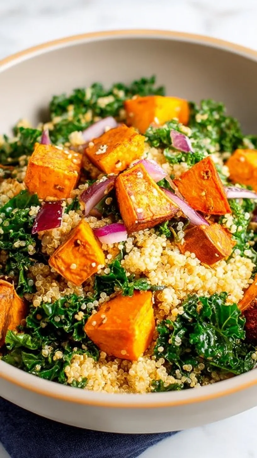 A vibrant bowl of quinoa salad with roasted sweet potatoes, massaged kale, and toasted pumpkin seeds.
